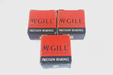 BACB10BH59F6 Three boxes of McGill precision bearings on a light gray background