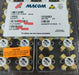 Packaged electronic components with MACOM branding on a clear plastic tray.